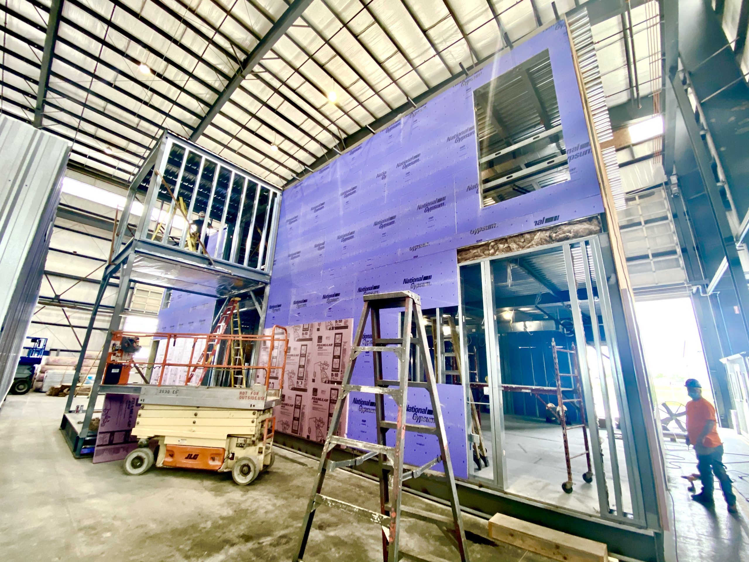 A building being built with scaffolding and ladders.