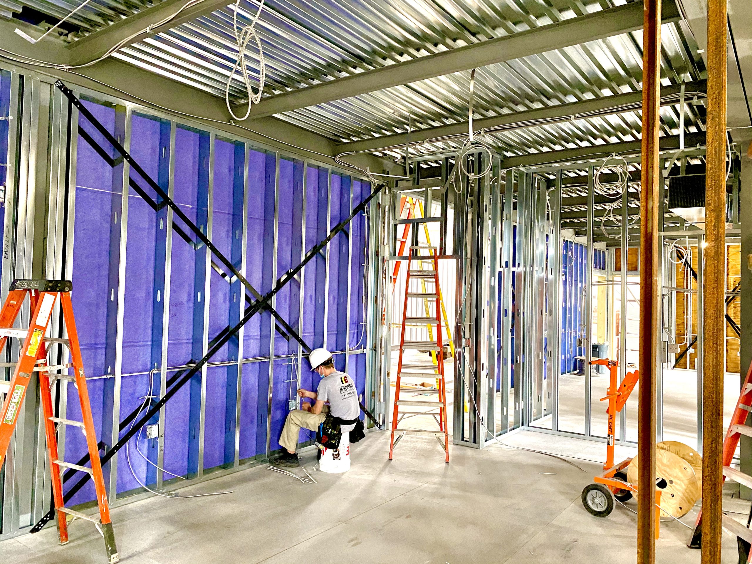 A man working on the wall of a building.