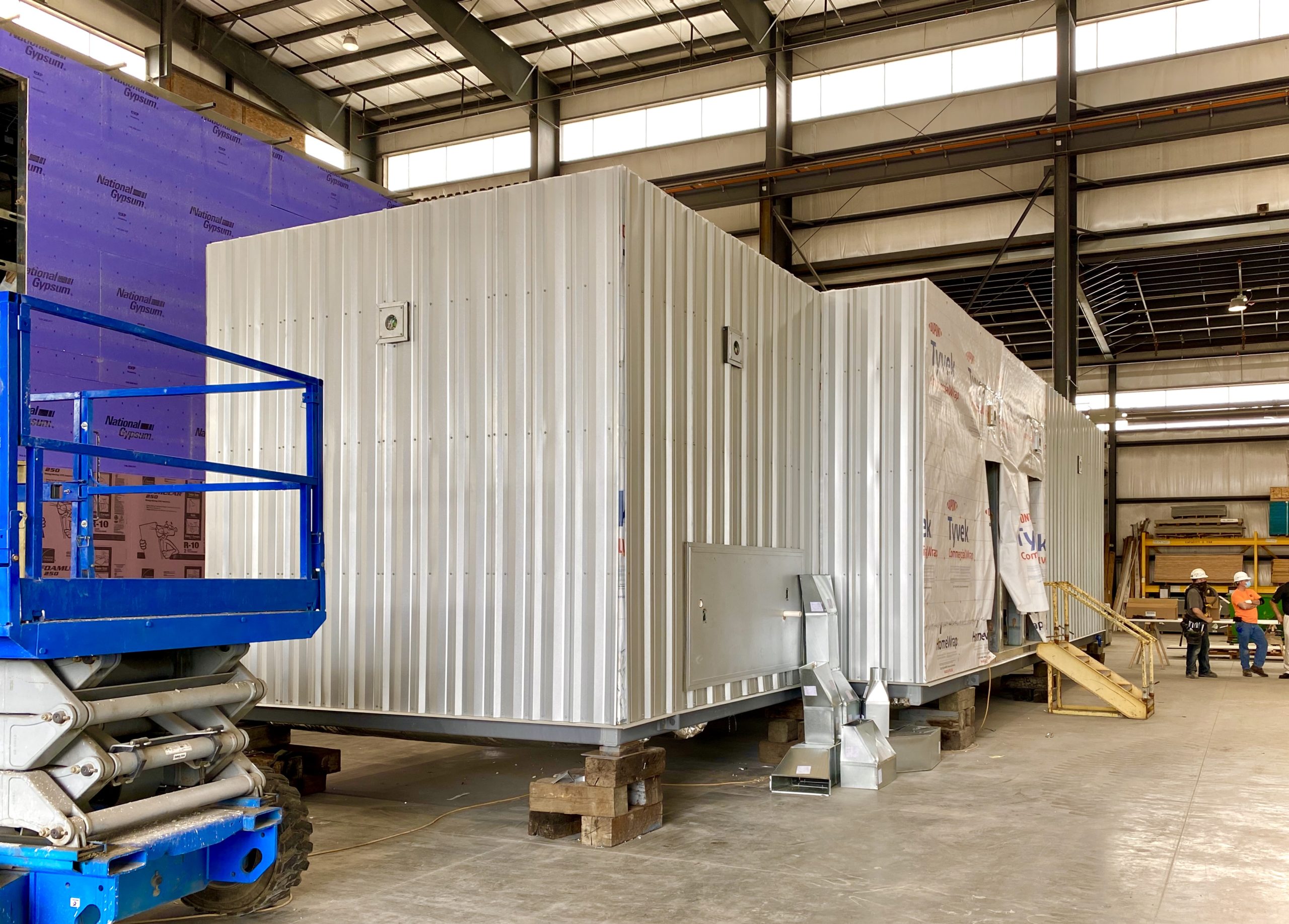 A large white container sitting in the middle of a warehouse.