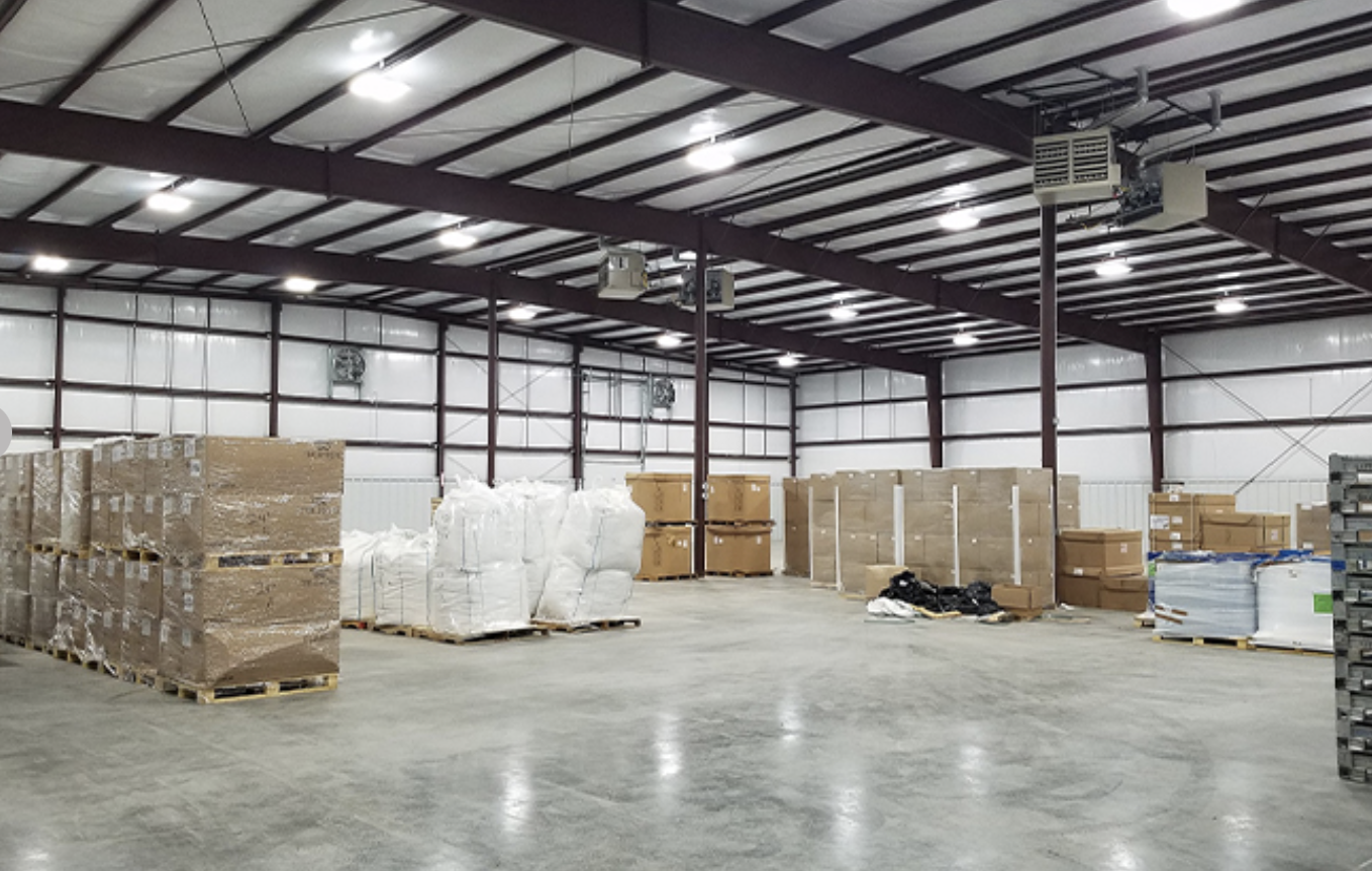 A warehouse with boxes and pallets in it.