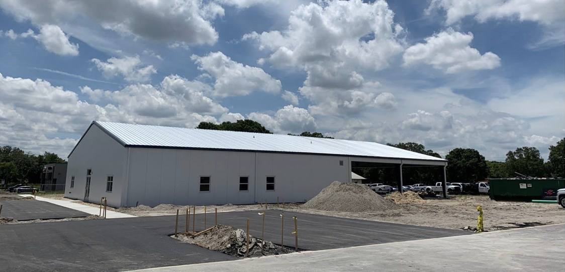 A building that is under construction with some dirt on the ground.
