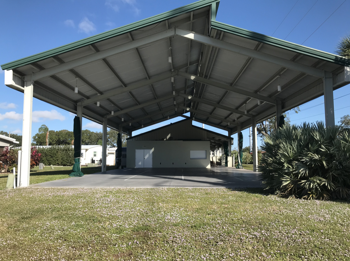 A large open metal structure with a garage.